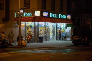 The corner, the stoop, a park-bench... The corner stores of the Bronx are a place to meet and commiserate, to enjoy the fresh air and escape the humidity. The deli is always a place to catch up on all of the neighborhood news and not just from the newspapers.